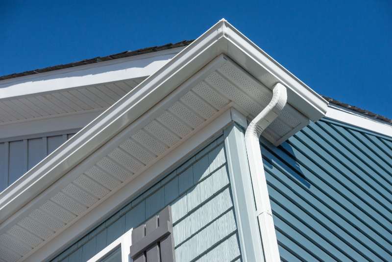 Exterior of a house showcasing a newly replaced gutter system, enhancing water management and home protection.
